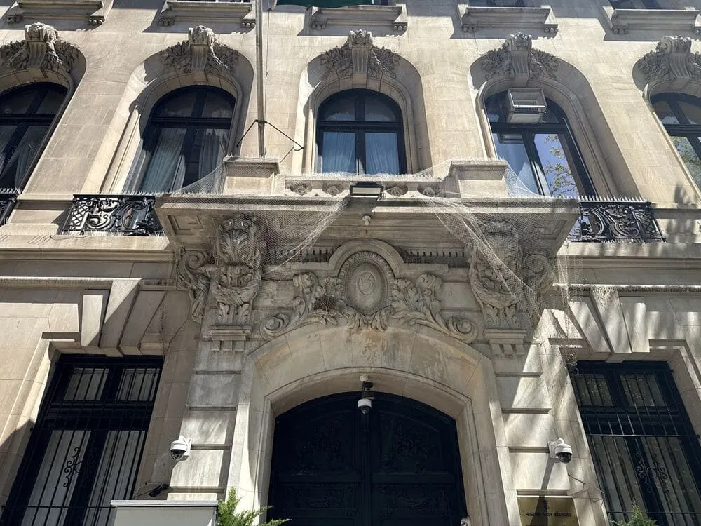 Elegant historic building facade with tall windows and ornate details, showing how pristine glass frames reputation from the street.